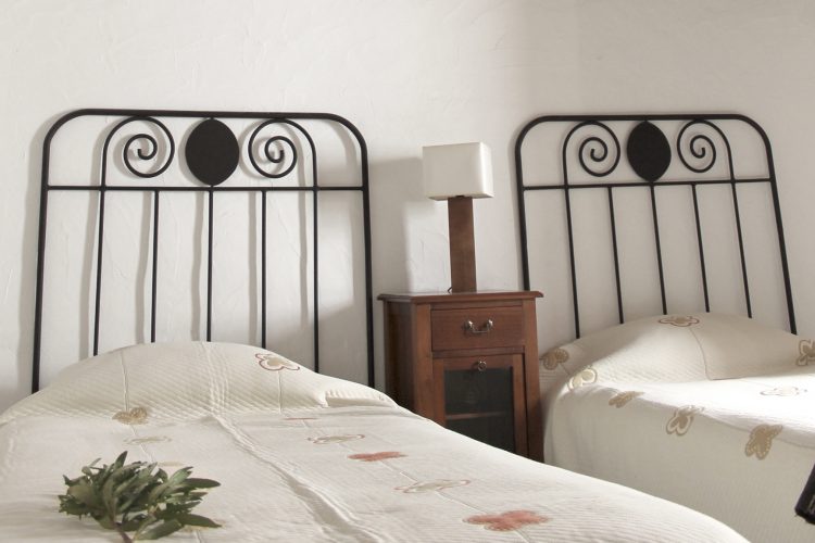 Comfortable bed with clean bathrobe in upscale hotel