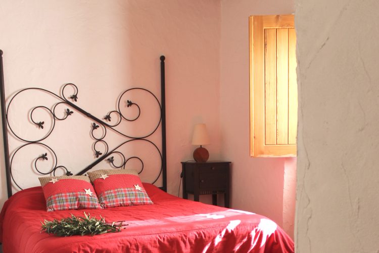 Comfortable bed with clean bathrobe in upscale hotel