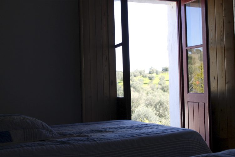 Comfortable bed with clean bathrobe in upscale hotel